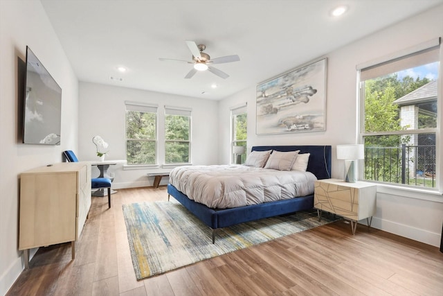 bedroom with hardwood / wood-style floors and ceiling fan