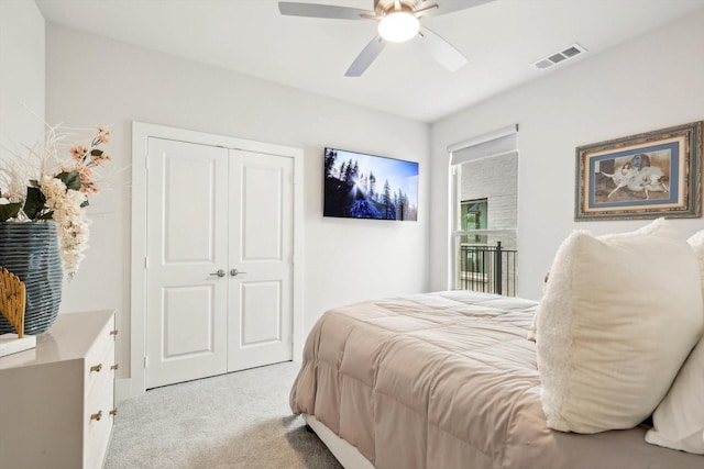 carpeted bedroom with ceiling fan and a closet