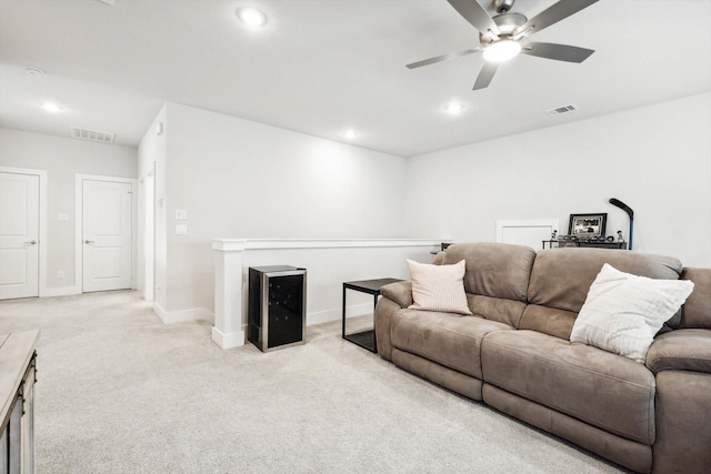 living room featuring light colored carpet and ceiling fan