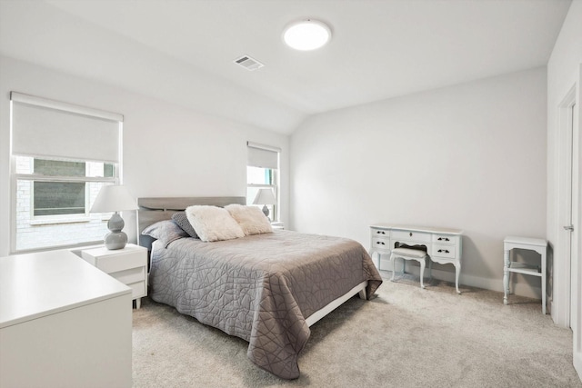 carpeted bedroom with vaulted ceiling