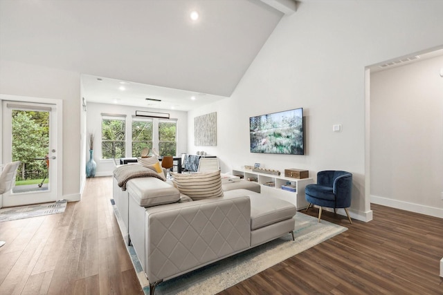 living room with hardwood / wood-style flooring, high vaulted ceiling, and beamed ceiling