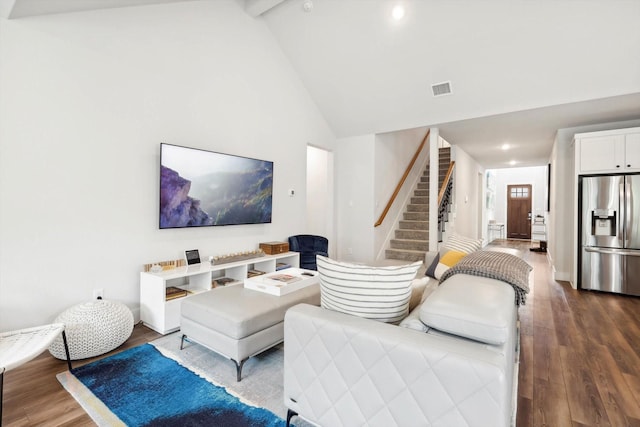 living room with beamed ceiling, hardwood / wood-style flooring, and high vaulted ceiling