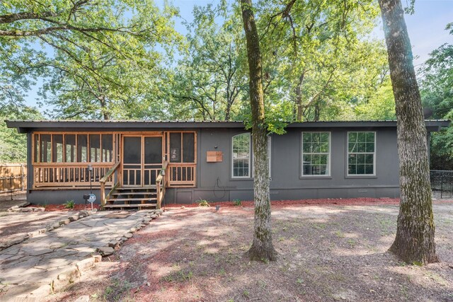 view of front of house featuring a sunroom