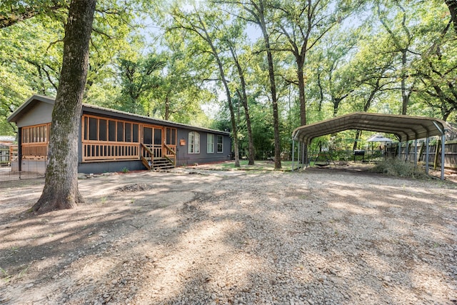 rear view of property featuring a carport