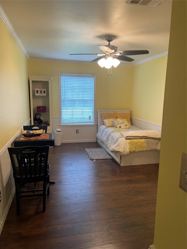 bedroom with dark hardwood / wood-style flooring, ornamental molding, and ceiling fan