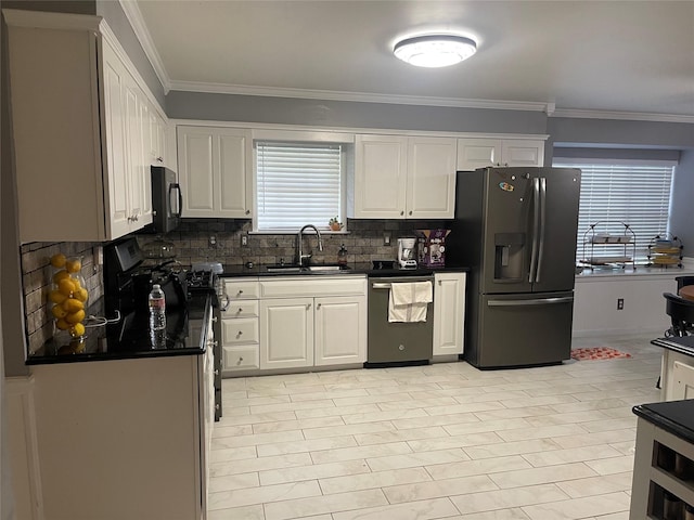 kitchen featuring crown molding, appliances with stainless steel finishes, sink, and white cabinets