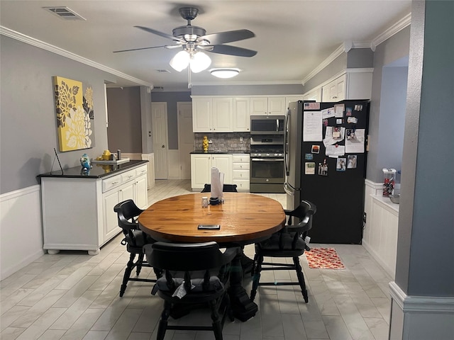 dining room featuring ornamental molding and ceiling fan