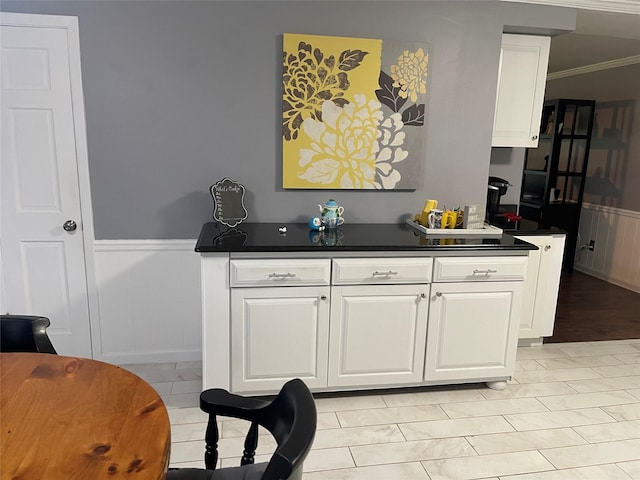 interior space with white cabinetry and ornamental molding