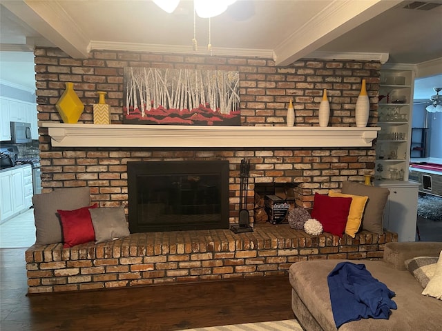 living room with crown molding, wood-type flooring, beam ceiling, and a brick fireplace