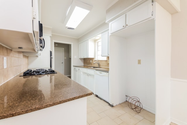 kitchen featuring white cabinetry, dishwasher, and sink