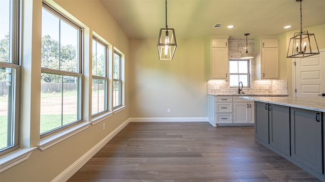 kitchen featuring plenty of natural light and white cabinetry