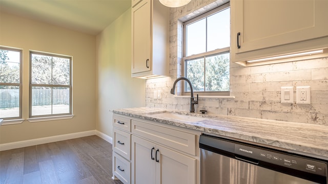 kitchen with light stone counters, dark hardwood / wood-style floors, white cabinetry, and stainless steel dishwasher