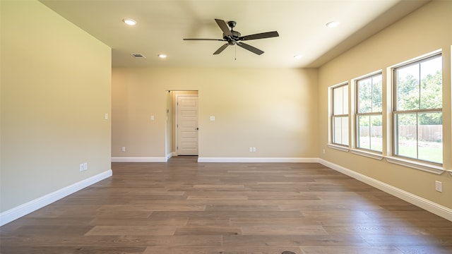 empty room with ceiling fan and hardwood / wood-style floors