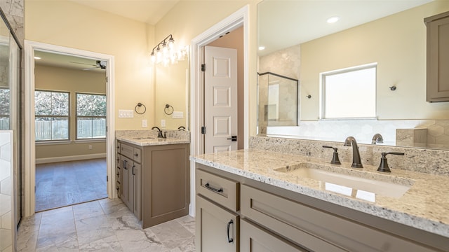 bathroom with ceiling fan, vanity, and an enclosed shower