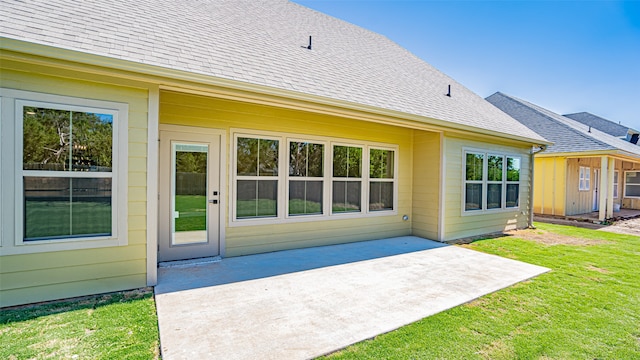 back of house with a yard and a patio area