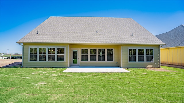 rear view of house featuring a yard and a patio area