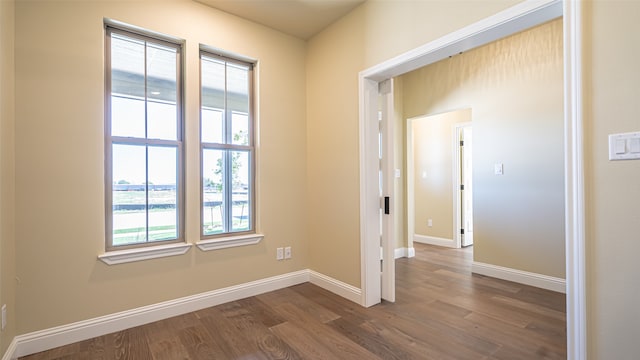 unfurnished room with hardwood / wood-style floors