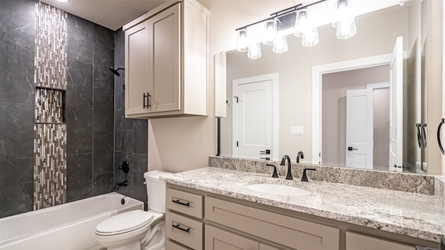 full bathroom featuring tiled shower / bath, vanity, and toilet