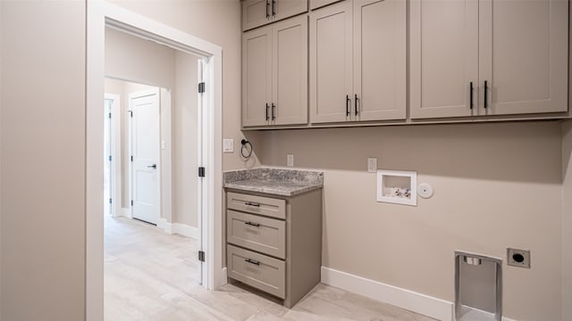 washroom featuring hookup for a washing machine, cabinets, and hookup for an electric dryer