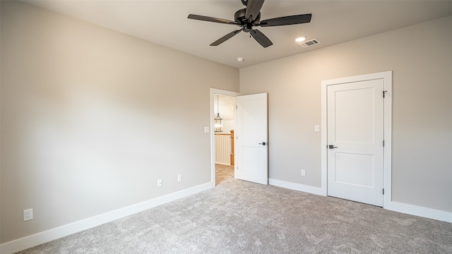 unfurnished bedroom featuring ceiling fan and light carpet