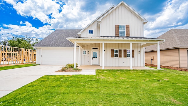 view of front of home with a front lawn, a garage, and covered porch