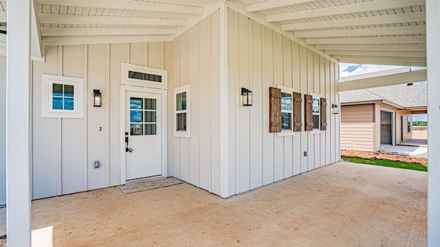 view of exterior entry featuring a patio area