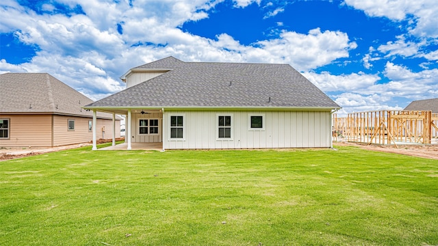 back of property featuring a yard and a patio