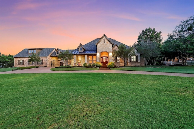 french country style house with a lawn