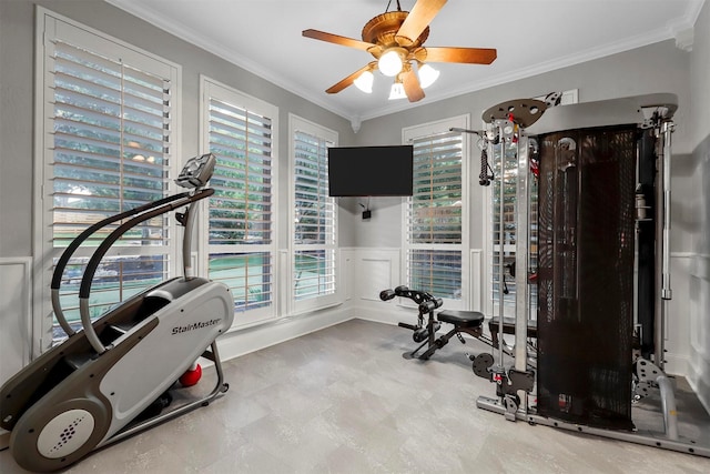 exercise area featuring plenty of natural light, ornamental molding, and ceiling fan