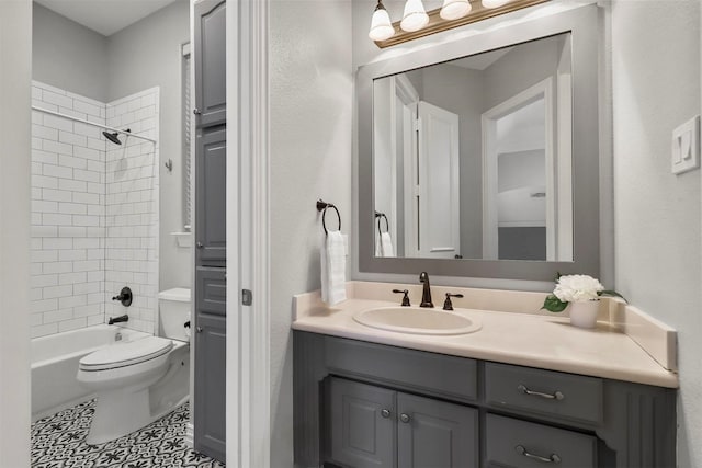 full bathroom featuring tiled shower / bath combo, vanity, tile patterned floors, and toilet