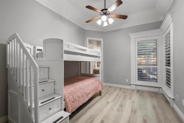 bedroom with light hardwood / wood-style flooring, ornamental molding, and ceiling fan