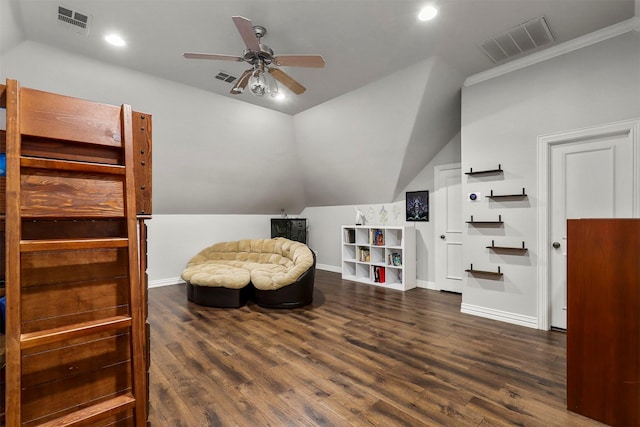 sitting room featuring dark hardwood / wood-style floors, vaulted ceiling, ornamental molding, and ceiling fan