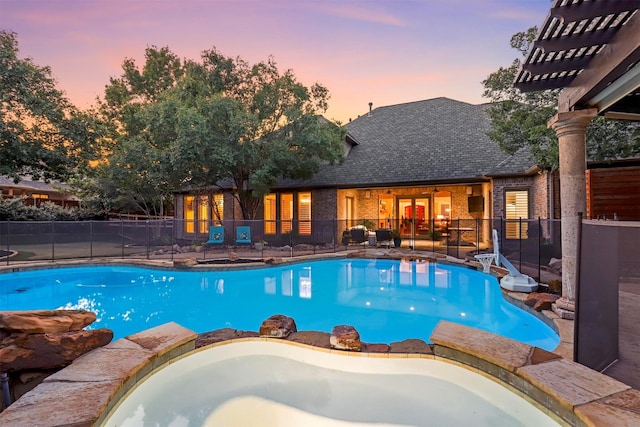 view of pool at dusk