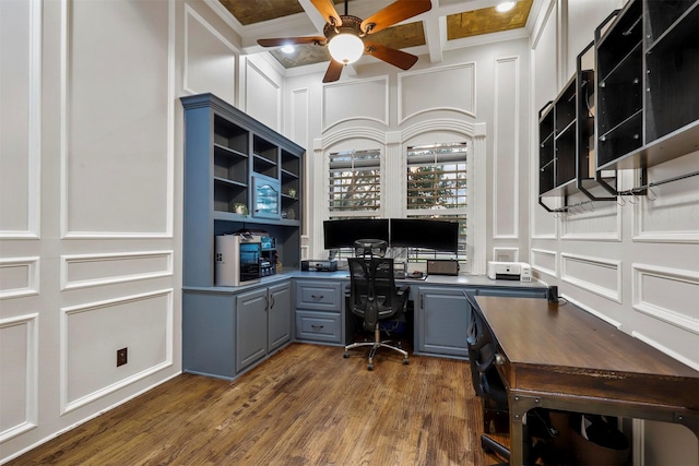 office area featuring beamed ceiling, dark hardwood / wood-style flooring, ornamental molding, coffered ceiling, and ceiling fan