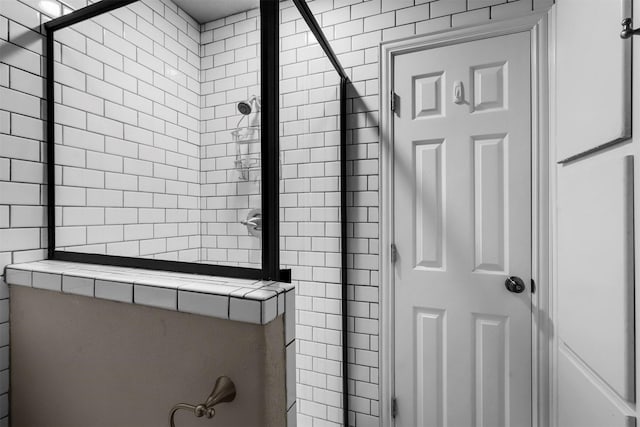 bathroom with tiled shower