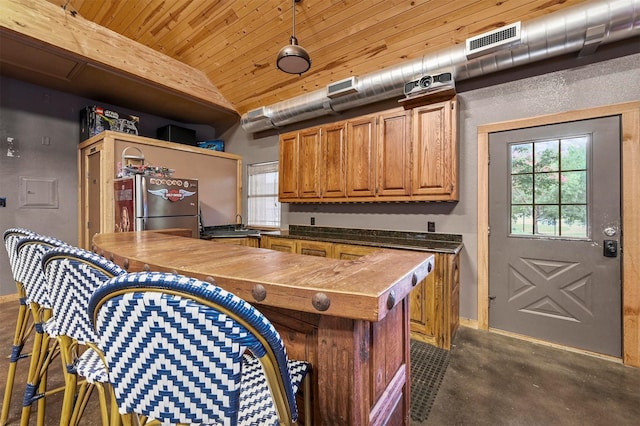 kitchen featuring stainless steel fridge and wood ceiling