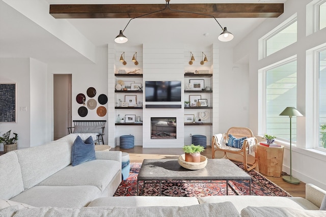 living room with light hardwood / wood-style floors and beam ceiling