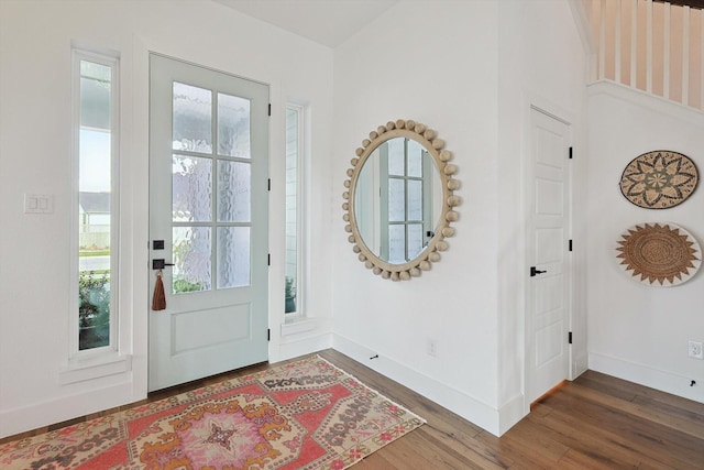 entryway with dark wood-style floors and baseboards