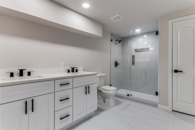 bathroom with tile patterned floors, an enclosed shower, vanity, and toilet