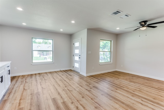 unfurnished living room featuring ceiling fan, plenty of natural light, and light hardwood / wood-style floors