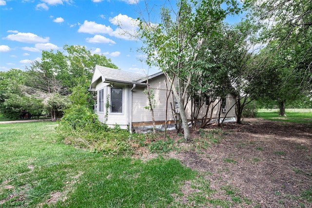 view of property exterior featuring a lawn