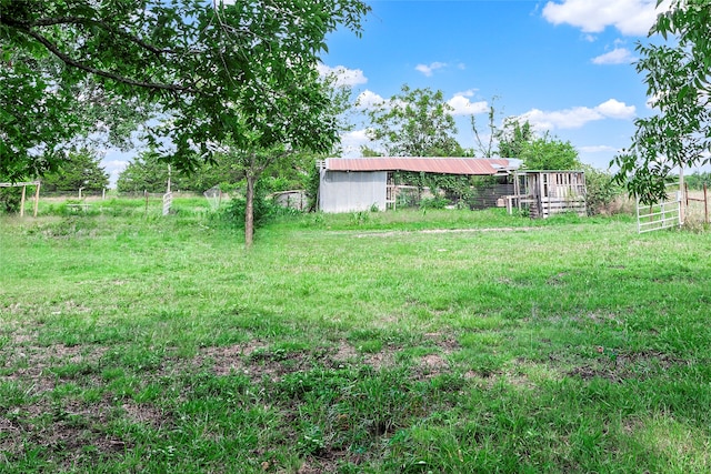 view of yard featuring an outbuilding and a rural view