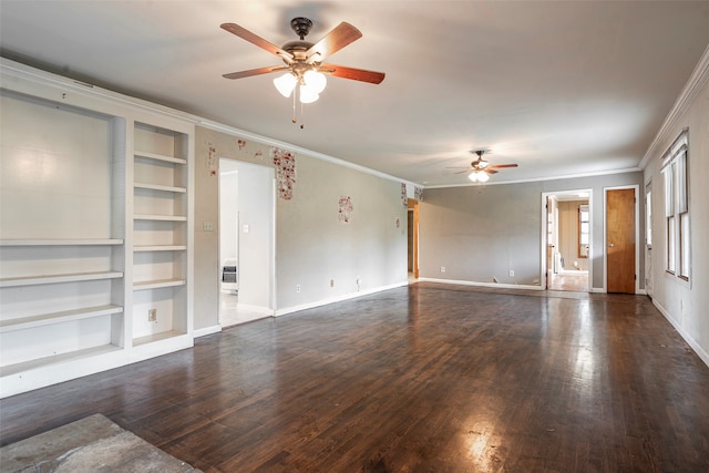 unfurnished living room with built in shelves, dark hardwood / wood-style floors, ceiling fan, and crown molding