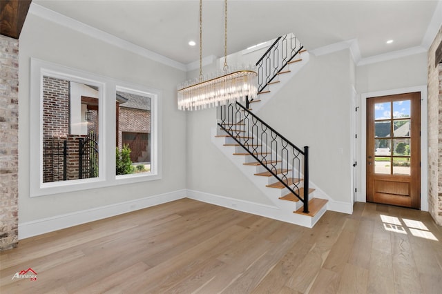 foyer entrance featuring crown molding and wood-type flooring