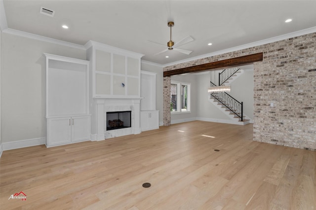 unfurnished living room with ceiling fan, crown molding, and light hardwood / wood-style flooring