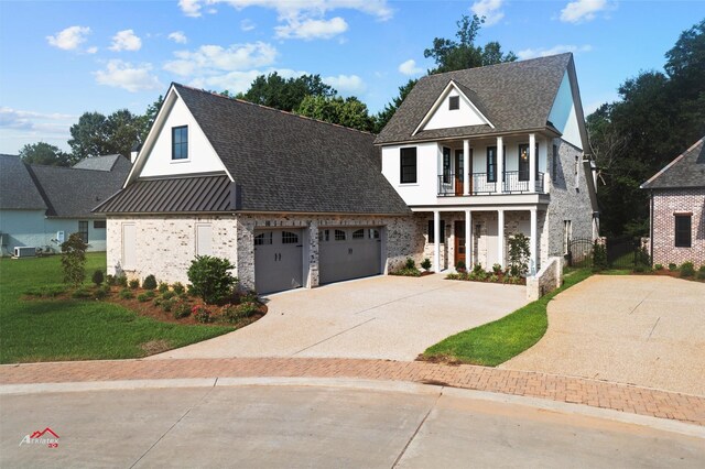 view of front facade featuring a balcony, a front lawn, and a porch