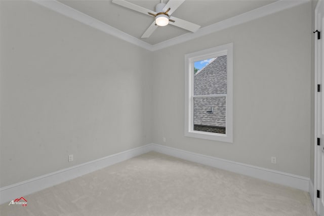 carpeted empty room with ceiling fan and crown molding