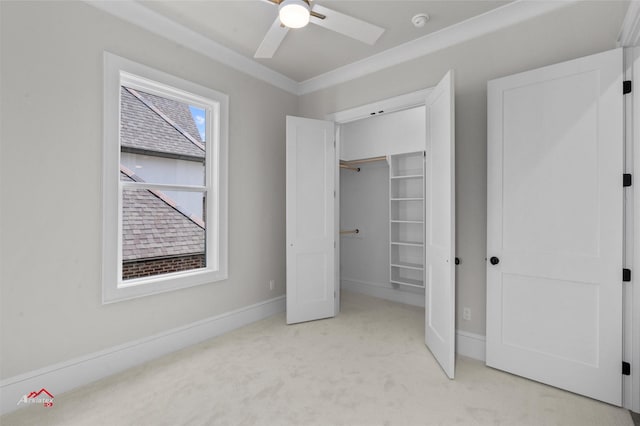 unfurnished bedroom featuring ceiling fan, light colored carpet, a closet, and ornamental molding