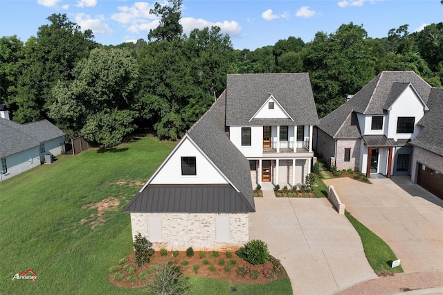 view of front of property with a front yard, a porch, and a balcony