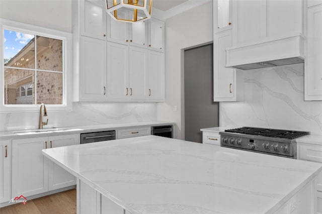 kitchen featuring decorative backsplash, pendant lighting, white cabinets, and sink